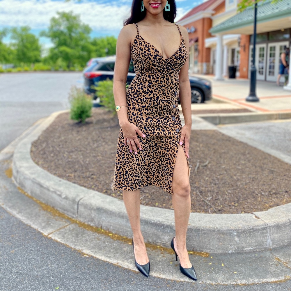 Leopard print sleeveless cocktail dress with a symmetrical buttoned design.